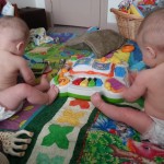 back of twin babies in diapers