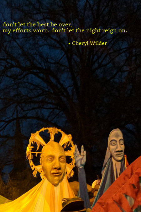 lifesize puppets of sun and man at night parade