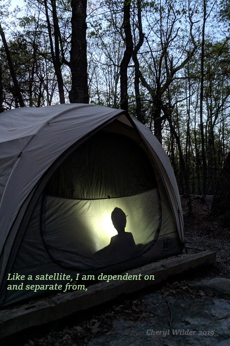 silhouette of child in tent at dusk