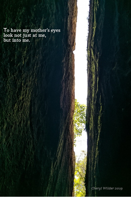 looking up at the sky between two large rock faces