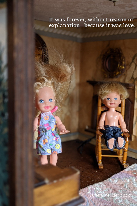 male doll sits in rocking chair with a female doll in doll house
