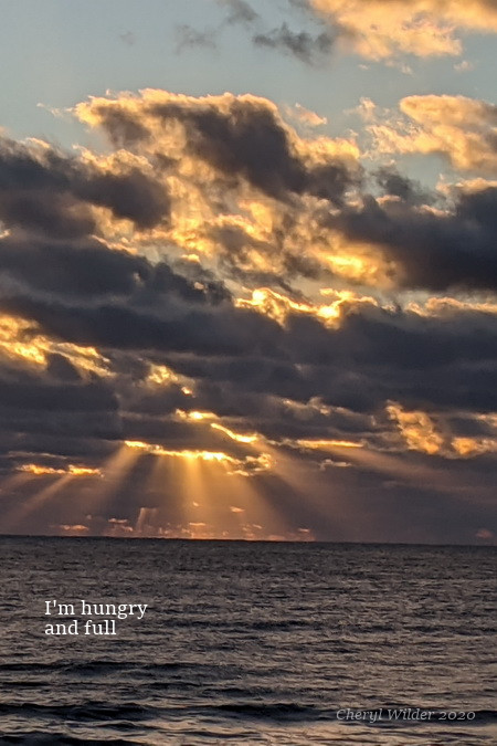 sunrise through dark clouds over the Atlantic Ocean